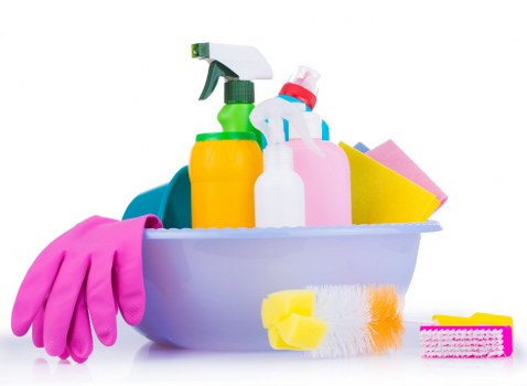 Cleaner working safely with protective equipment during routine cleaning